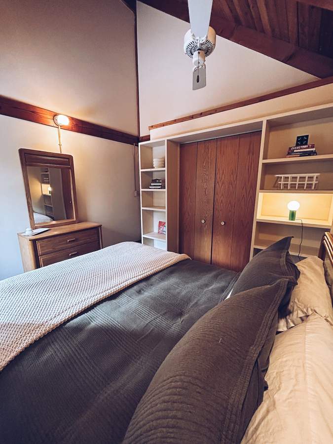 Upstairs bedroom at Lofty Cabin with a queen bed beneath the sloped ceiling
